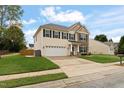 Two-story home features a manicured lawn, two-car garage, and stone and siding accents at 203 Green Pasture Rd, Mebane, NC 27302
