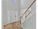 Bright foyer with hardwood floors, staircase, and a view into adjoining room at 2049 Rainy Lake St, Wake Forest, NC 27587