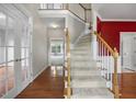 Inviting foyer with hardwood floors, staircase, and white trim at 210 Mediate Dr, Raleigh, NC 27603