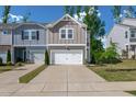 Modern townhomes featuring garages, well-manicured lawns, and inviting curb appeal at 212 Brook Farm Ln, Fuquay Varina, NC 27526
