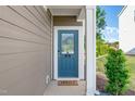 Inviting entryway features a blue front door with glass and a welcoming 
