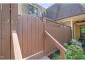 Charming townhome entrance featuring a wooden gate and stairs leading to the front door at 213 Summerwalk Cir, Chapel Hill, NC 27517