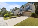View of home with long driveway and manicured lawn at 221 Hammond Wood Pl, Morrisville, NC 27560