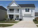 Charming two-story home with a covered porch and well-maintained lawn at 222 Oak Branch Trl, Garner, NC 27529