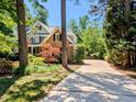 Charming two-story home featuring a welcoming front porch and a well-manicured lawn at 2405 Flints Pond Cir, Apex, NC 27523