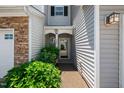 Inviting entryway to a townhome with a decorative door and manicured bushes for added curb appeal at 2609 Asher View Ct, Raleigh, NC 27606