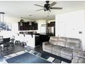 Open-concept living room and kitchen with hardwood floors, recessed lighting, and a ceiling fan for comfortable living at 267 Darecrest Ln, Wendell, NC 27591