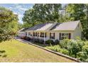 Charming one-story home with manicured lawn, inviting porch, and lush landscaping at 2913 Escondido Farm Rd, Garner, NC 27529
