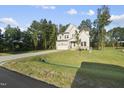 Well-manicured lawn and long driveway leading to this charming two-story home at 300 Scotland Dr, Youngsville, NC 27596
