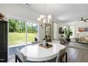Dining room with a white round table, stylish chairs, and sliding glass doors that lead to the backyard at 3017 Ginger Hill Ln, Durham, NC 27703