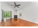 Spacious living room featuring hardwood floors, a fireplace, and a sliding glass door to the outdoors at 302 Red Elm Dr, Durham, NC 27713