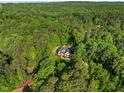 Stunning aerial view of a secluded home surrounded by lush green forest at 3035 Tavistock Dr, Durham, NC 27712