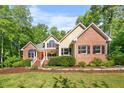 Inviting home with a charming front porch and well-maintained landscaping at 3035 Tavistock Dr, Durham, NC 27712