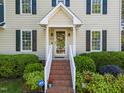 Inviting home entrance with brick stairs and lovely landscaping creating a warm, welcoming ambiance at 3204 Terrel Mill Rd, Raleigh, NC 27616