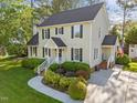 Beautiful two-story home featuring manicured landscaping and mature trees enhancing its curb appeal at 3204 Terrel Mill Rd, Raleigh, NC 27616