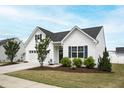 Attractive one-story home with white siding, neat landscaping, and a driveway at 321 Everly Mist Way, Wake Forest, NC 27587
