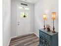 Inviting foyer featuring a stylish console table, lamps, and a view of the front door at 321 Everly Mist Way, Wake Forest, NC 27587