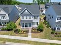 Aerial view of a gray home with well-maintained landscaping in a neighborhood at 3224 Wishing Well Wynd, Apex, NC 27502