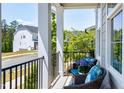 Cozy front porch featuring comfortable seating with blue cushions and a neighborhood view at 3224 Wishing Well Wynd, Apex, NC 27502