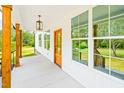 Close-up of the porch showcasing the architectural details and natural light pouring in from the large windows at 3281 Phillips Chapel Rd, Haw River, NC 27258