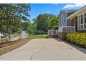 Spacious driveway providing ample parking, leading up to a home with manicured landscaping at 3425 Brentwood Rd, Raleigh, NC 27604