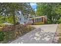 An exterior elevation view showcasing the home's well-kept lawn, driveway, and curb appeal at 3425 Brentwood Rd, Raleigh, NC 27604