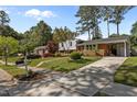 A charming home with a well-manicured lawn and convenient driveway at 3501 Arrowwood Dr, Raleigh, NC 27604