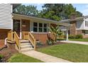 Inviting front porch featuring wood railings and steps leading up to the front door at 3501 Arrowwood Dr, Raleigh, NC 27604