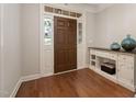 Bright entryway with hardwood floors, front door with sidelights, and decorative console table at 3612 Carriage Dr, Raleigh, NC 27612