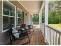 Cozy front porch with rocking chairs, offering a relaxing outdoor seating area with views at 380 Perdues Rd, Louisburg, NC 27549