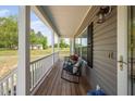 Quaint front porch with comfortable seating, ideal for enjoying the peaceful surroundings and outdoors at 380 Perdues Rd, Louisburg, NC 27549