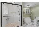 Modern bathroom featuring a glass-enclosed shower, soaking tub, and elegant fixtures at 408 Blooming Meadows Rd, Holly Springs, NC 27540