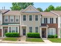 Charming townhouse with manicured landscaping, inviting entryway, and neutral exterior at 4535 Sugarbend Way, Raleigh, NC 27606