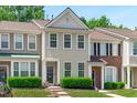 Charming townhouse with manicured landscaping, inviting entryway, and neutral exterior at 4535 Sugarbend Way, Raleigh, NC 27606