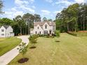 Expansive aerial view shows a well-manicured lawn, circular driveway, and a beautiful single-Gathering home at 46 Bonterra Way, Chapel Hill, NC 27516