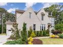 Beautiful home featuring painted brick, manicured landscaping, and an attached garage at 46 Bonterra Way, Chapel Hill, NC 27516