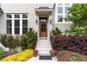 Charming front entrance with wood door, black accents, and vibrant landscaping at 46 Bonterra Way, Chapel Hill, NC 27516