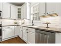 Bright kitchen featuring white cabinets, stainless steel appliances, subway tile backsplash, and stone countertops at 5213 Holly Ridge Farm Rd, Raleigh, NC 27616