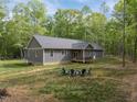 Spacious backyard featuring a wooden deck and a cozy fire pit area, perfect for outdoor gatherings at 5402 Shealtiel Way, Rougemont, NC 27572