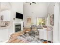 Open living space with hardwood floors, fireplace, and sliding door to a deck at 5504 Creekdale Cir, Raleigh, NC 27612