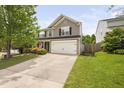 This two-story home boasts a pristine lawn and a spacious two-car garage at 5512 Bridgeman Ct, Durham, NC 27703
