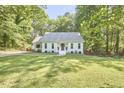 Inviting single-story home with lush green lawn and mature trees in the front yard at 5642 Falkirk Dr, Durham, NC 27712