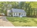 Well-maintained home featuring a manicured lawn, landscaping, and a charming entryway at 5642 Falkirk Dr, Durham, NC 27712