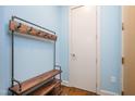 Hallway with hardwood floors, coat rack with wood bench, and white walls at 618 N Boylan Ave # 622, Raleigh, NC 27603