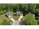 An aerial view of a home with mature trees, landscaping, and driveway at 624 Moultonboro Ave, Wake Forest, NC 27587