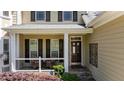 Inviting front porch with seating area and classic architectural details at 624 Moultonboro Ave, Wake Forest, NC 27587