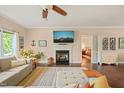Comfortable living room boasts a fireplace, hardwood floors, and a view into the bedroom at 6324 Daybreak Dr, Wake Forest, NC 27587