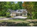 Charming single-story home with manicured lawn, lush landscaping, and a spacious driveway at 6509 Mountain Brook Ln, Raleigh, NC 27615
