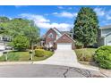 Beautifully maintained two-story brick home with an attached two-car garage and a neatly landscaped front yard at 7 Bonham Ct, Durham, NC 27703