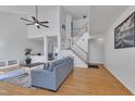 Bright and airy living room with high ceilings, hardwood floors, a ceiling fan, and staircase at 7 Bonham Ct, Durham, NC 27703
